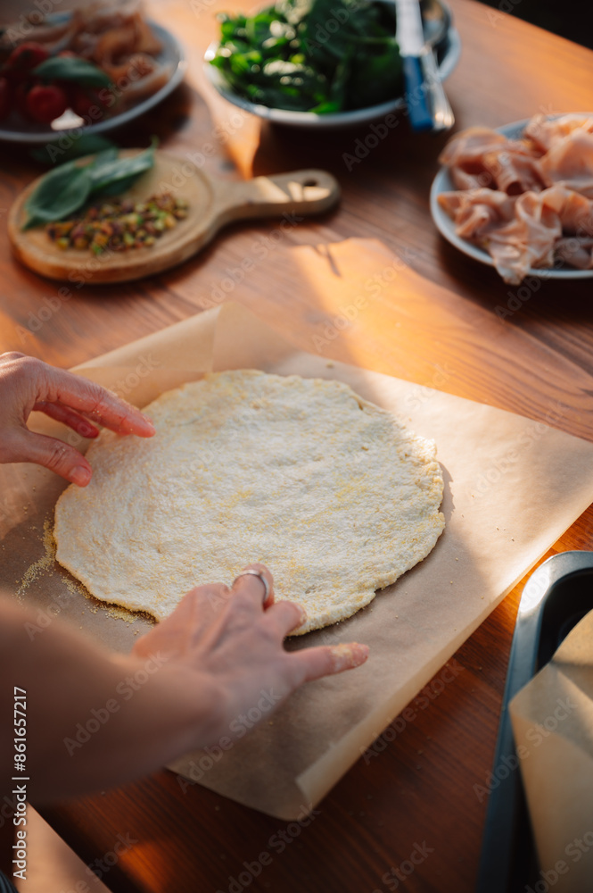 Making pizza dough. Female chef. Outdoor Dining table of Homemade Pizza, Fresh Ingredients and wine. Italian dream countryside romantic dinner Making pizza dough. Female chef. Outdoor Dining table of Homemade Pizza, Fresh Ingredients and wine. Italian dream countryside romantic dinner