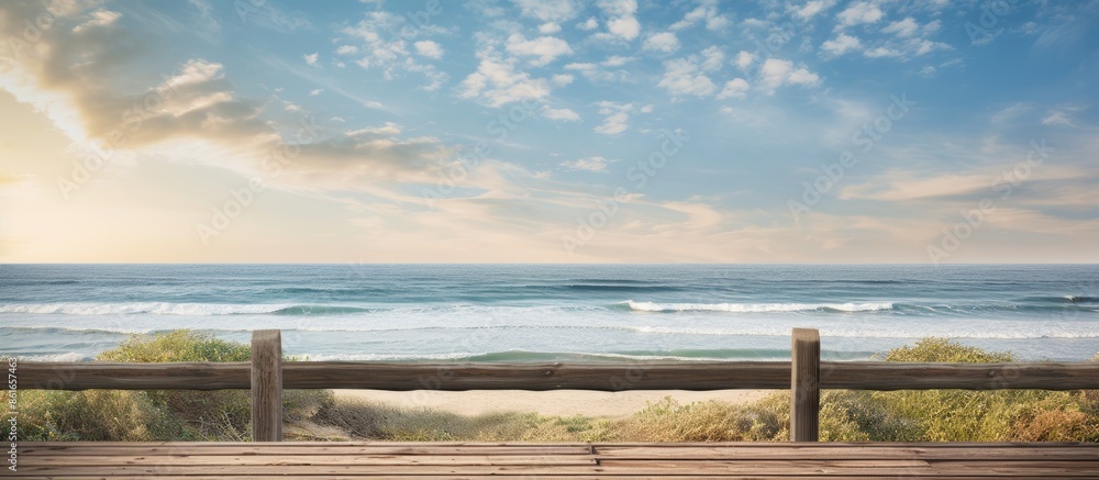 Fototapeta premium A wooden fence on a pier overlooking the sea offers a tranquil setting with a beautiful copy space image.