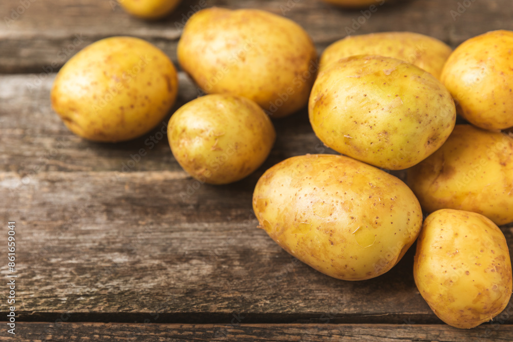 Young potatoes. Fresh potatoes on a wooden background.Harvesting collection. organic, freshly dug potatoes. Agricultural background. Vegan. Vegetables.Place for text.Copy space Young potatoes. Fresh potatoes on a wooden background.Harvesting collection. organic, freshly dug potatoes. Agricultural background. Vegan. Vegetables.Place for text.Copy space