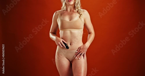 Sexual, toys and body of woman with erotic, pleasure and self care on background of studio. Sexy, girl and sensual stimulation equipment for to relax with satisfaction and touch skin in lingerie