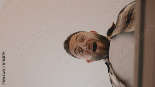 Capture the thrill of unboxing from a unique perspective, showcasing a man exuberantly opening a delivery box, encapsulating the joy of receiving a new order. photo