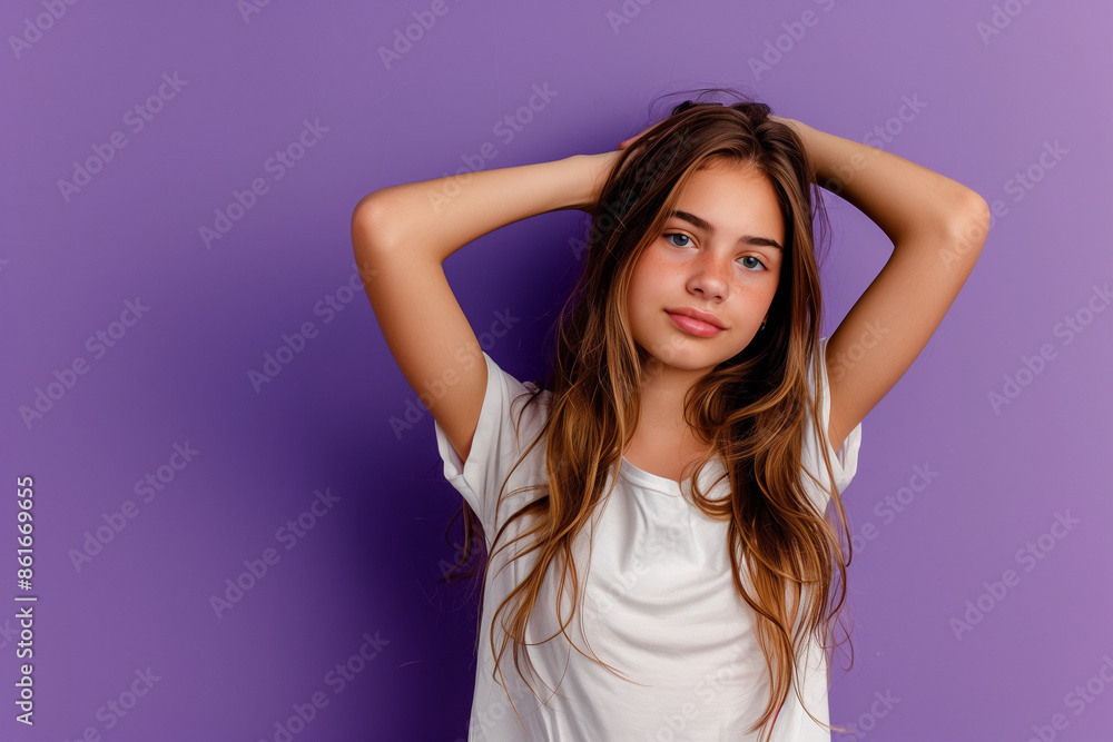 Portrait of a serene young girl in a white shirt, touching her hair, set against a vivid purple background, ideal for lifestyle and fashion content Portrait of a serene young girl in a white shirt, touching her hair, set against a vivid purple background, ideal for lifestyle and fashion content
