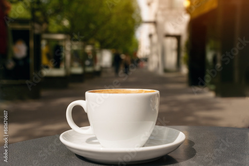 Cup of Coffee on Sunny Day in City Street photo