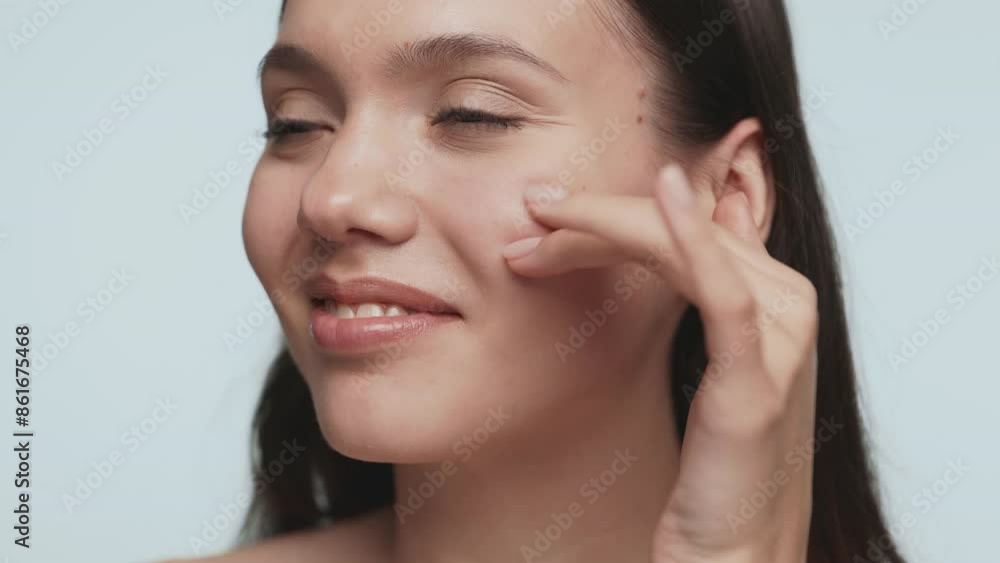 A closeup view capturing a moment of a skincare routine, highlighting the gentle touch of a hand on clear skin. A closeup view capturing a moment of a skincare routine, highlighting the gentle touch of a hand on clear skin.
