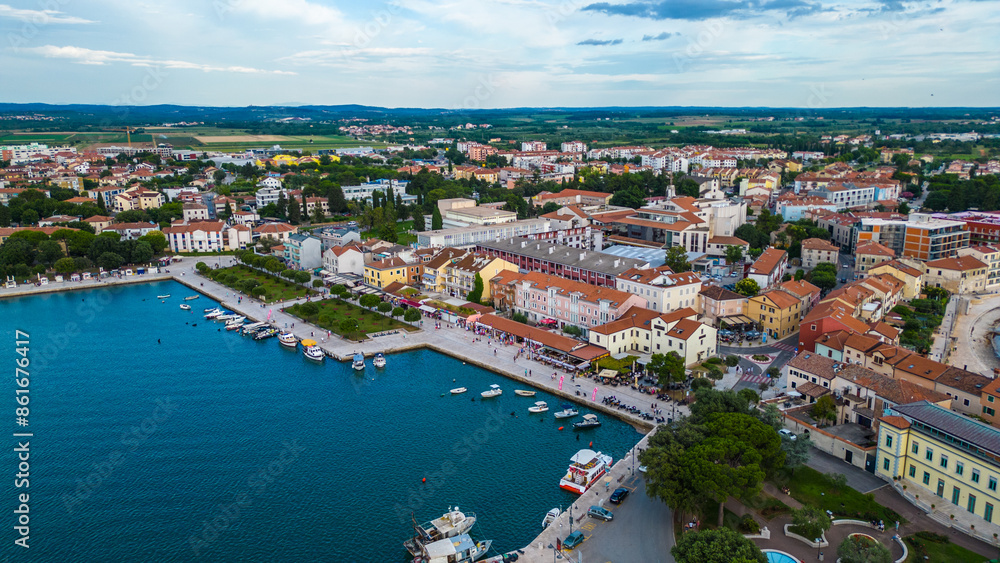 A stunning aerial view of Umag, a charming coastal town in Istria, Croatia. Known for its beautiful beaches, historic architecture, and vibrant marina, Umag offers a perfect blend of relaxation A stunning aerial view of Umag, a charming coastal town in Istria, Croatia. Known for its beautiful beaches, historic architecture, and vibrant marina, Umag offers a perfect blend of relaxation