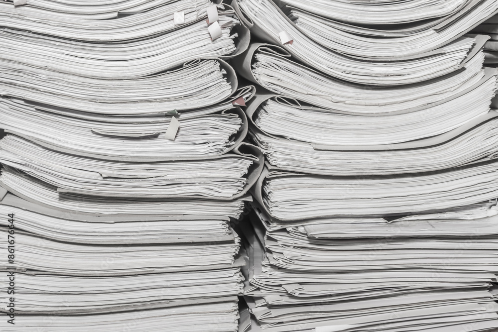 Paper documents stacked in archive. folders with documents on the shelves of archive room. Office shelves in the closet full of files Paper documents stacked in archive. folders with documents on the shelves of archive room. Office shelves in the closet full of files