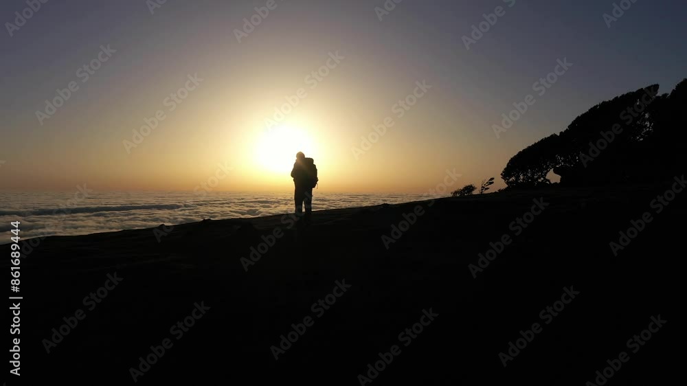 Silhouette of Man on Hill at Sunrise. Clouds Inversion. Aerial Drone Shot. Madeira, Portugal. Orbiting Silhouette of Man on Hill at Sunrise. Clouds Inversion. Aerial Drone Shot. Madeira, Portugal. Orbiting
