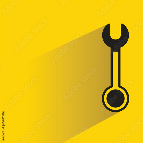 wrench tool with shadow on yellow background