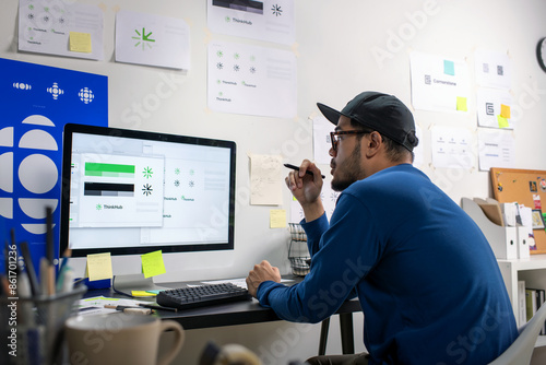 Wallpaper Mural Asian graphic designer working on logo designs, using computers, designing logos, and showcasing the corporate identity and logo design process. Torontodigital.ca