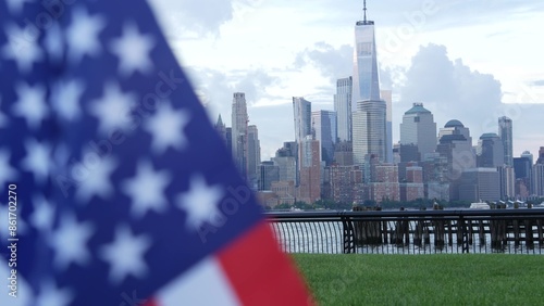 New York City waterfront skyline, Manhattan Downtown World Trade Center skyscraper. Cityscape from New Jersey, United States. American flag 11 September, USA. Independence and Remembrance symbol. Wind