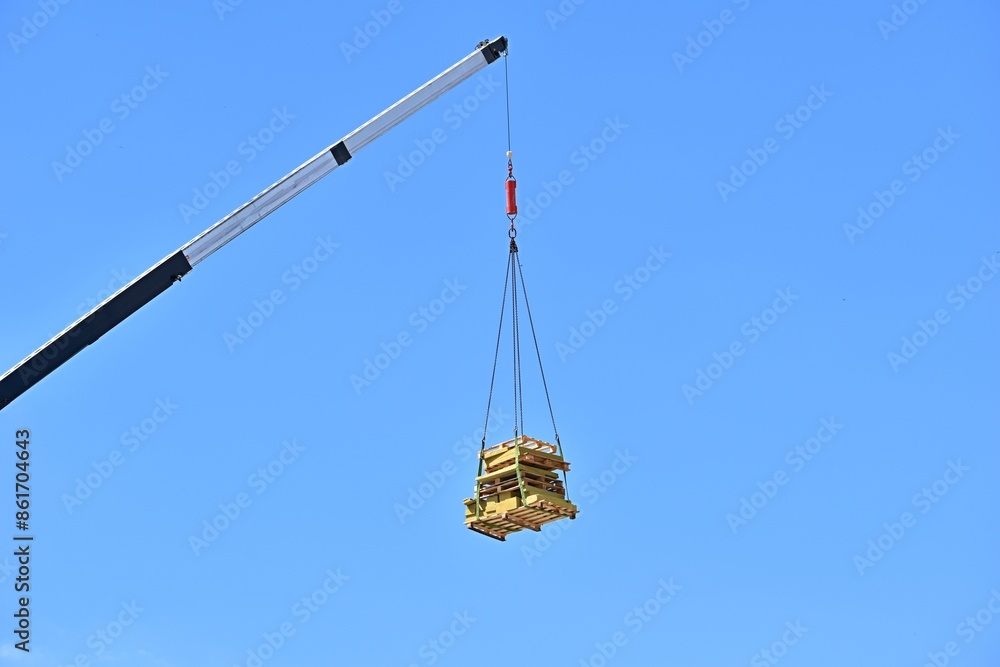wooden pallets hanging against blue sky background wooden pallets hanging against blue sky background
