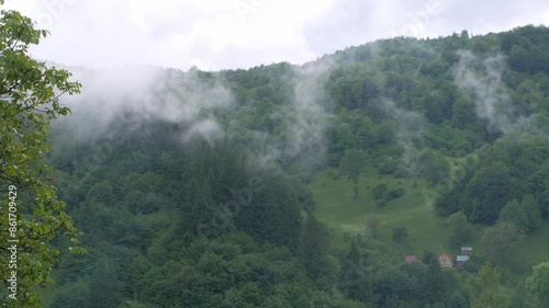 Misty Carpathian Mountains fog clouds 4K footage motion landscape. High altitude mountain view in valley Scenic forest rainy day, the mist is enshrouding the hills trees Carpathians wood Europe travel