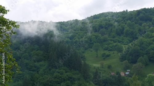 Misty Carpathian Mountains fog clouds 4K footage motion landscape. High altitude mountain view in valley Scenic forest rainy day, the mist is enshrouding the hills trees Carpathians wood Europe travel