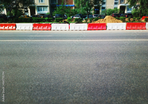 Red and white road limiters at construction area backdrop photo