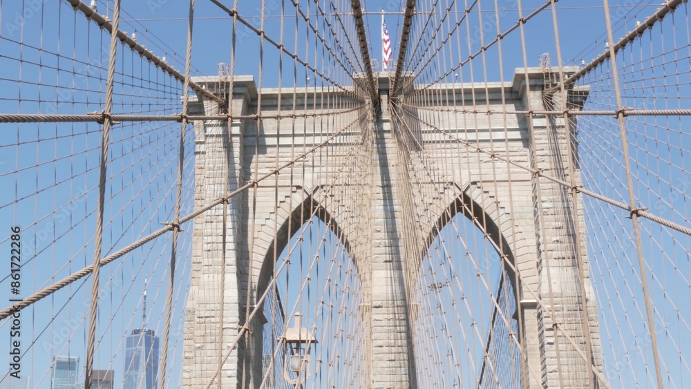 Obraz premium Brooklyn Bridge to Manhattan downtown, cables and blue sky. New York City iconic symbol, USA travel destination. Architecture of United States of America, tourist landmark. Famous cable-stayed bridge.