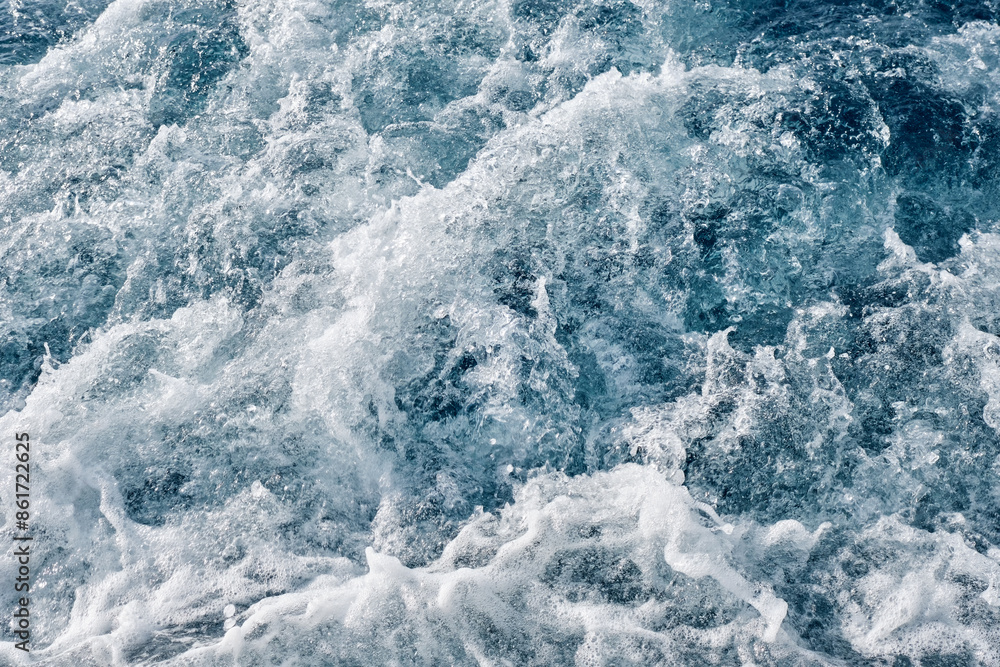 Sea waves, bubbles and white foam over the blue sea formed by the motor of a powerboat. Sea waves, bubbles and white foam over the blue sea formed by the motor of a powerboat.