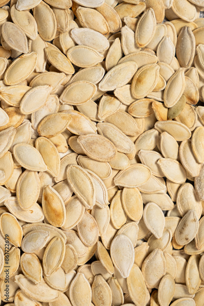 Close-up of unpeeled pumpkin seeds from above. Close-up of unpeeled pumpkin seeds from above.