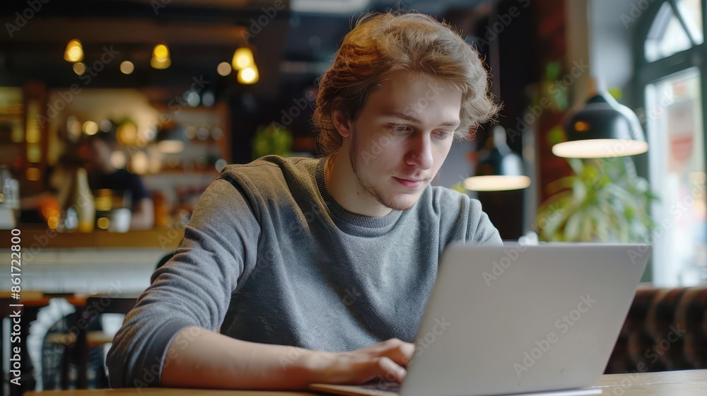 young male freelancer working on laptop in cafe student entrepreneur lifestyle portrait young male freelancer working on laptop in cafe student entrepreneur lifestyle portrait
