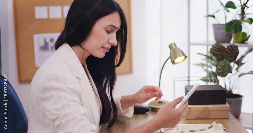 Businesswoman Rubs Eyes Tiredly While Browsing Smartphone Businesswoman Rubs Eyes Tiredly While Browsing Smartphone