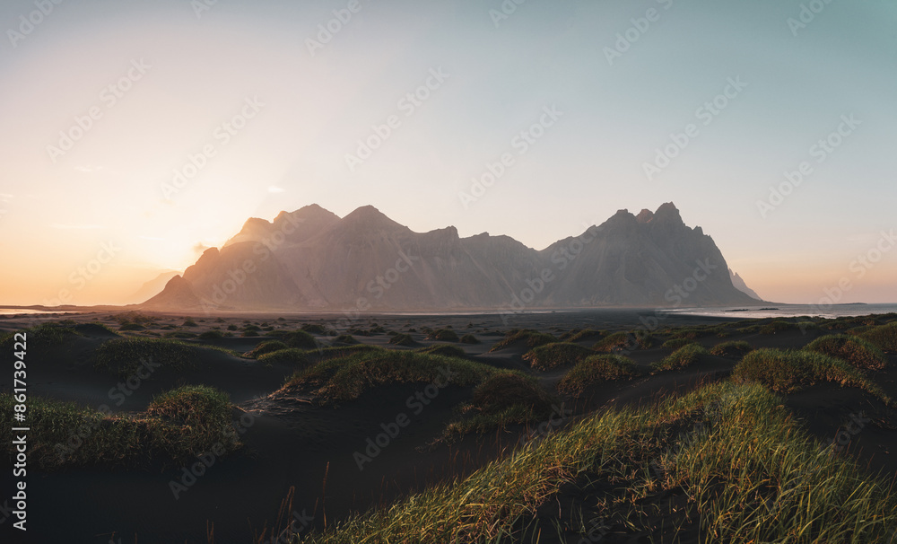 Stunning panoramic view of Vestrahorn, an impressive 454 metres tall mountain. It faces out to the sea on its southern side and is surrounded by a black sandy coastline. Iceland.