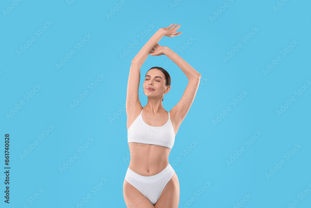 Diet and weight loss concept. Beautiful young woman with slim body against light blue background Diet and weight loss concept. Beautiful young woman with slim body against light blue background