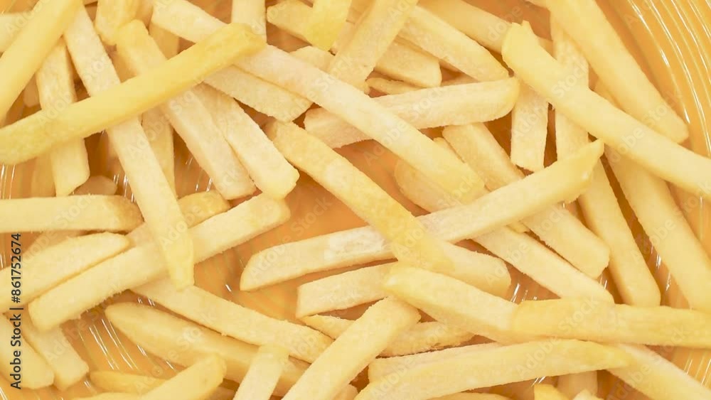 frozen potato chips on yellow plate,view directly above,rotating video. frozen potato chips on yellow plate,view directly above,rotating video.