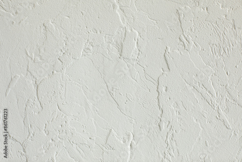 Texture of white plaster on concrete wall, handmade. Modern stucco with irregular surface and grain. Construction, interior or exterior design. Background of grunge grey cement structure, rough top