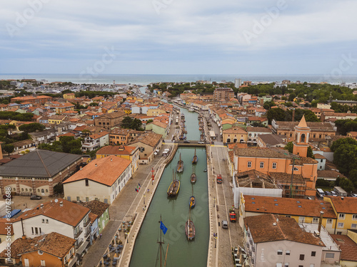 ITALY, 24 June 2024: aerial and panoramic view in 4k of Cesenatico with its beach, its sea and its canal with historic boats. We are on the Romagna coast in the province of Rimini photo