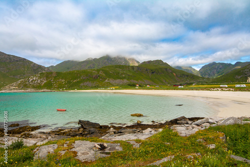 Panorama of Vik beach near Hauklandstranda beach with turquoise sea and mountains on a background on Vestvågøy island, Lofoten islands, Norway. Sea and mountains. photo