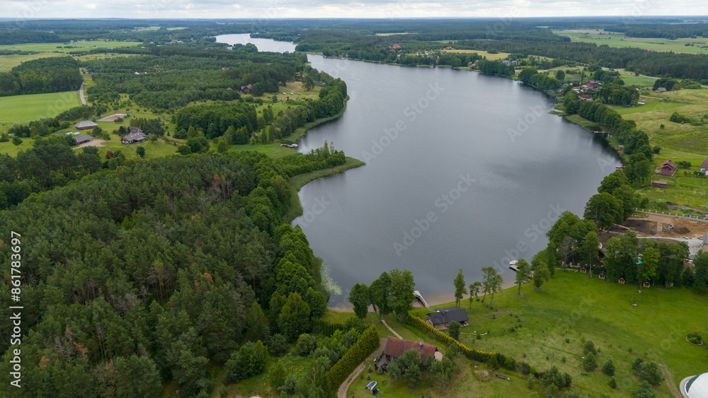 Drone photography of lake, forest and houses near it during summer day Drone photography of lake, forest and houses near it during summer day
