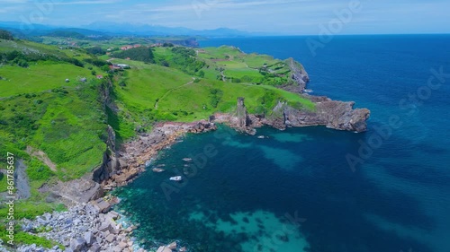 Coastal landscape of meadows and cliffs on the coast of Ensenada Calderon. Aerial view from a drone. Alfoz de Loredo Municipality. Cantabrian Sea. Cantabria. Spain. Europe photo