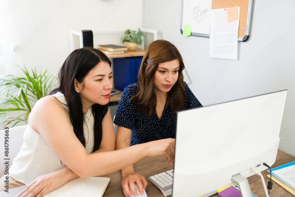 Two women collaborating on a project at their startup office, showcasing teamwork and partnership dynamics in the workplace Two women collaborating on a project at their startup office, showcasing teamwork and partnership dynamics in the workplace