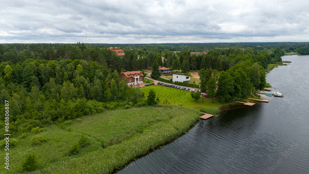 Drone photography of lake, forest and houses near it during summer day Drone photography of lake, forest and houses near it during summer day