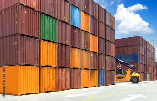 Busy international industrial port with freight and shipment docks and cargo containers.