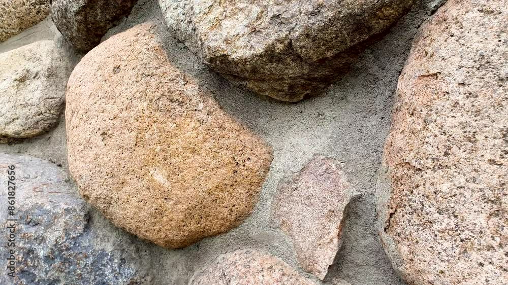 Stone wall of cobblestones. Natural stone wall. Stone wall of cobblestones. Natural stone wall.
