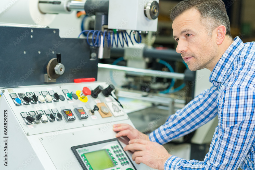 technician at controls of production line technician at controls of production line