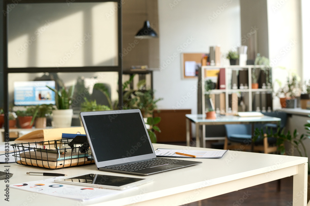 Background image of sunlit open office interior with laptop on workplace desk in focus, copy space Background image of sunlit open office interior with laptop on workplace desk in focus, copy space