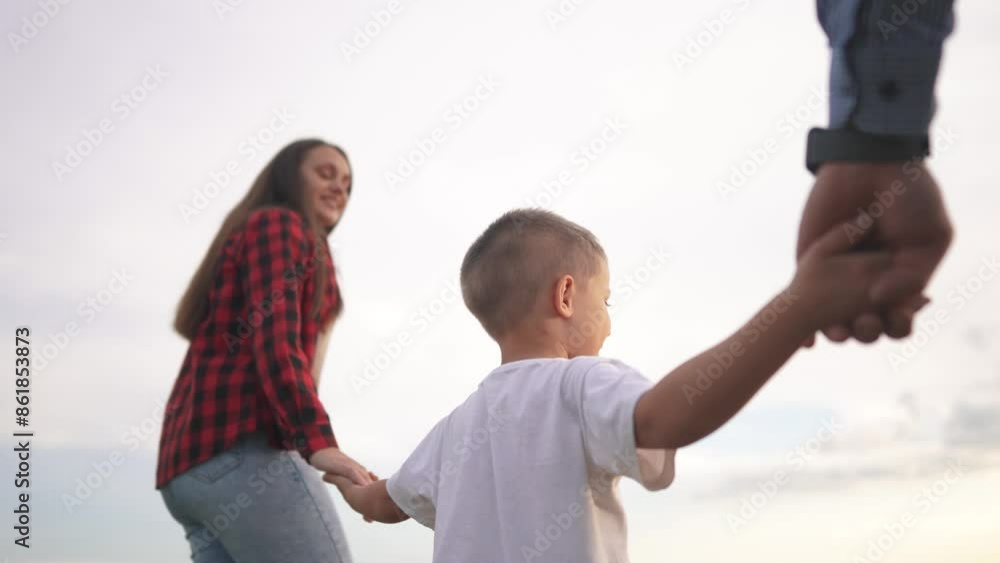 Family holding hands walk together in the park. Father happy silhouette concept. Parents and children walk playing in nature. Family of children with hands together walk in the park lifestyle nature. Family holding hands walk together in the park. Father happy silhouette concept. Parents and children walk playing in nature. Family of children with hands together walk in the park lifestyle nature.