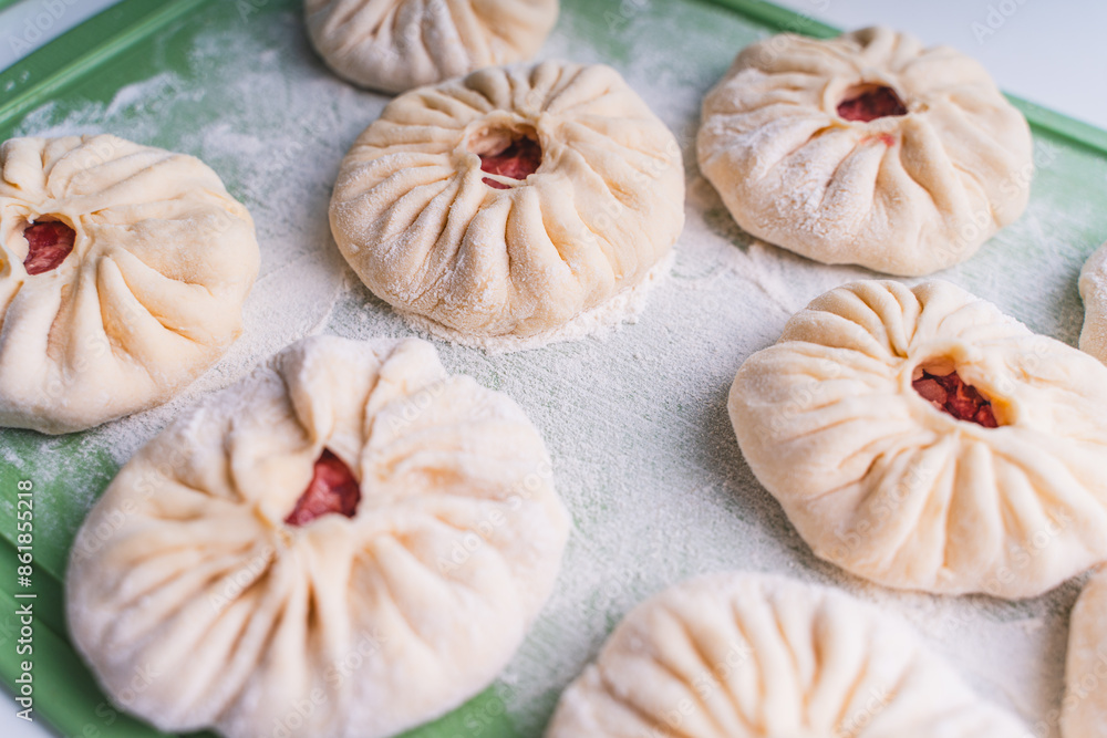 Fototapeta premium Close-up: open pies with meat or belyashi, ready for frying.