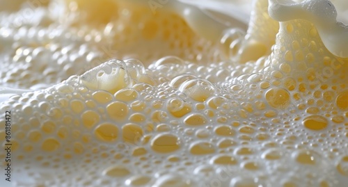 Close-Up of White Foamy Beer Bubbles on a Light Yellow Background