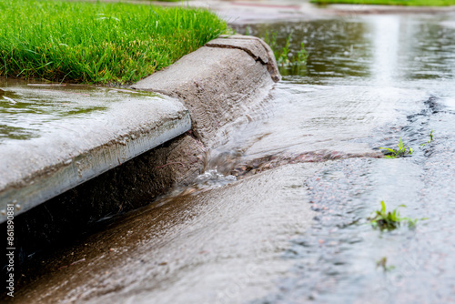 Принти на полотні Stormwater flowing into street intake drain after a rainstorm