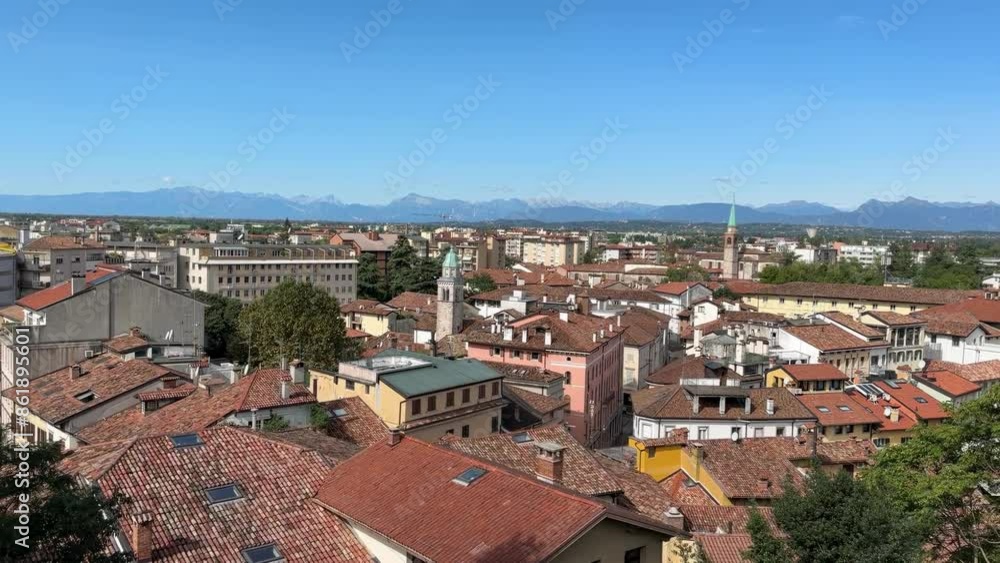 A city view with a blue sky and a white cloud. The city is full of buildings and has a lot of trees A city view with a blue sky and a white cloud. The city is full of buildings and has a lot of trees