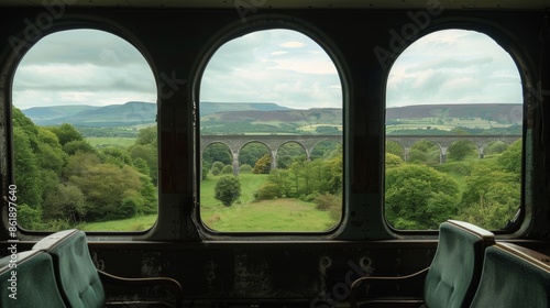 The rolling hills seem to stretch endlessly into the distance framed by the arches of the rail bridge. © Justlight