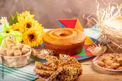 Festa Junina, beautiful rustic table with dishes containing various types of sweets for Festa Junina in Brazil, selective focus. photo