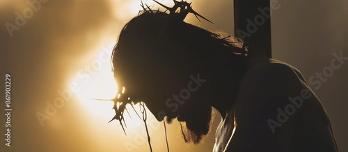 silhouette of Jesus Christ suffering at the cross and wearing the crown of thorns. Jesus Christ dying on cross for our sins. Christianity concept.