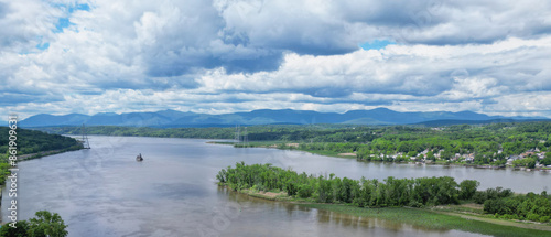 view of the hudson river and catskills mountains from a park in hudson new york valley (lighthouse, water clouds harbor coastline scene) aerial beautiful travel destination ny state public land