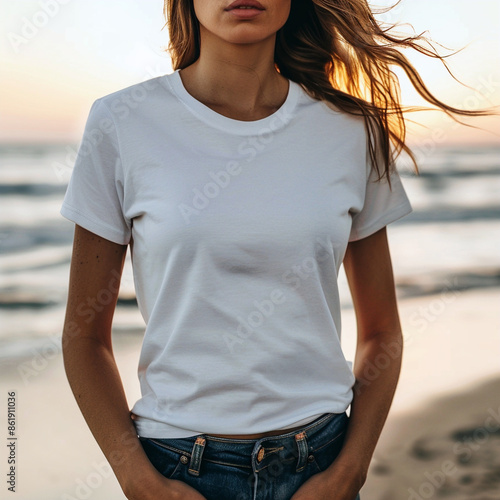 Anonymous model with long hair and white T-shirt, at sunset on the beach © PATRICIA