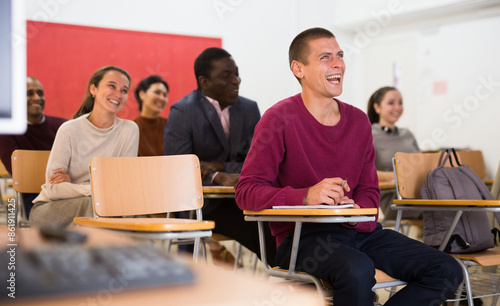 Lesson in the classroom of the university - students at their desks photo