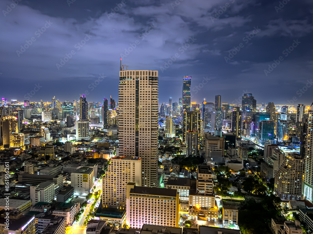 Fototapeta premium Bangkok BKK the city that never sleeps colourful lights of the buildings shops streets cars of the city and urban skyline view from one of the tallest Sky Tower in BKK