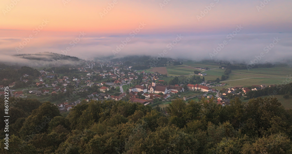 AERIAL: Village with historic monastery and rolling mists on a beautiful morning AERIAL: Village with historic monastery and rolling mists on a beautiful morning